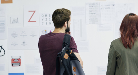 Two students looking at posters